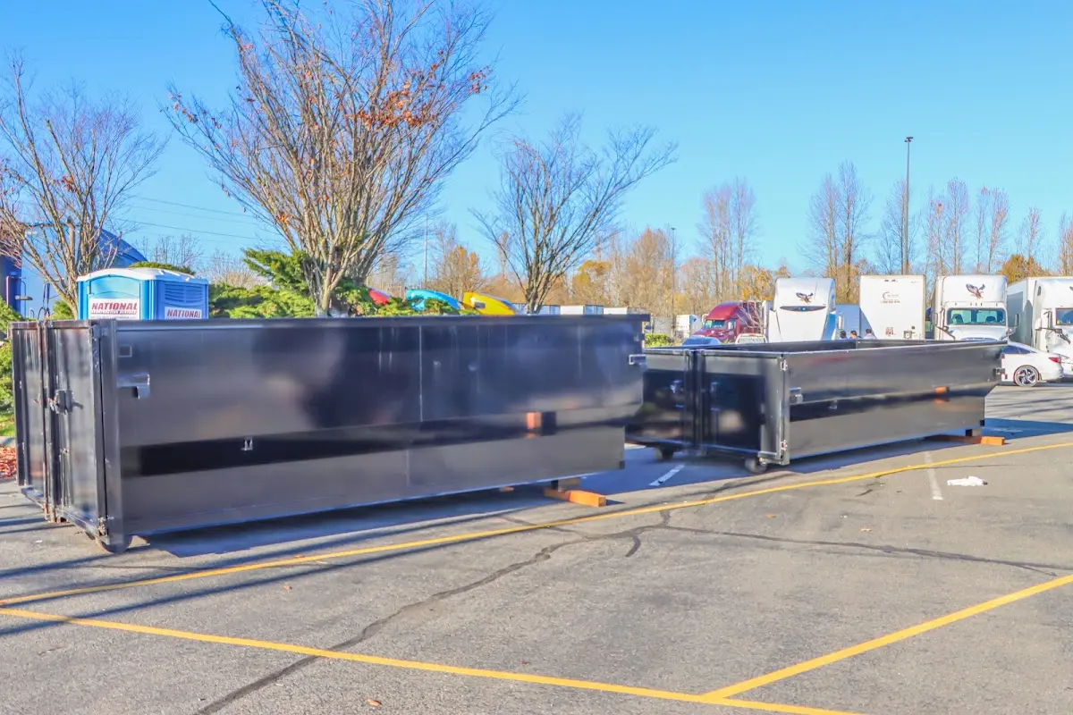 Professional dumpster rental service with roll-off container on residential driveway in South Berwick